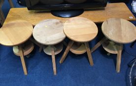 An oak bench and four swivel top stools