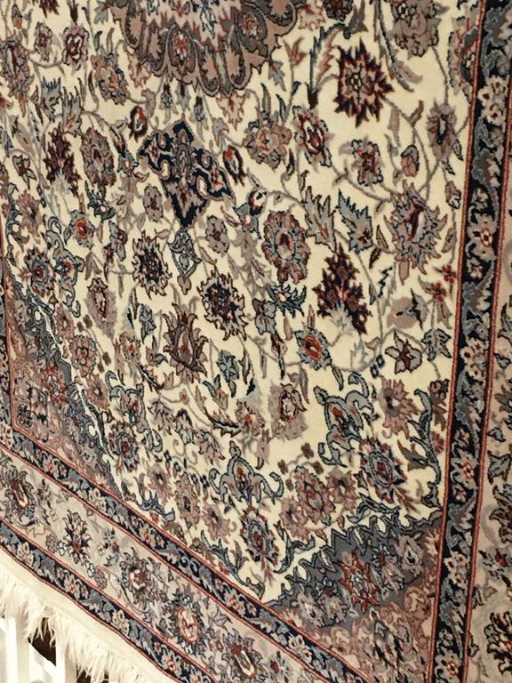 A good quality Persian cream ground rug, 128cm x 110cm