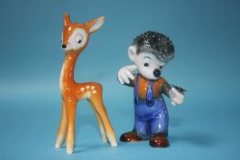 A Goebel model of a fawn and a Goebel model of a boy modelled as a hedgehog with a butterfly on