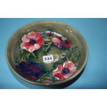 A Moorcroft shallow circular bowl, decorated with anemones, impressed mark, 22cm diameter