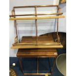 A copper pipework two tier shelf and a small table