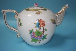 An oversized Herend porcelain teapot, decorated with butterflies and flowers