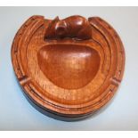 A Robert Mouseman Thompson dark oak horse shoe ashtray, with carved mouse