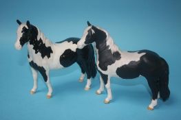 A Beswick 'Pinto Pony', piebald black and white gloss and a matt version (2)