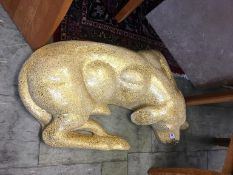Large gold coloured plaster and glass model of a dog