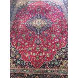A machine made Persian style rug, the ground with midnight blue central pole medallion, corner