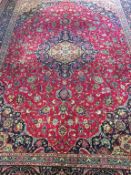 A machine made Persian style rug, the ground with midnight blue central pole medallion, corner