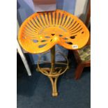 An orange tractor seat bar stool