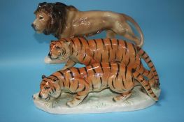 A German pottery group of two tigers and a lion