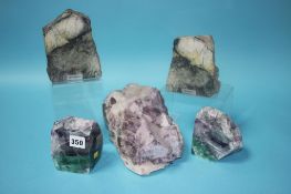 A large piece of amethyst, a pair of bookends and a pair of Skye marble book ends