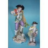 A Continental porcelain figure of a young man playing a flute and a small figure of a boy holding