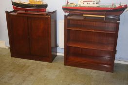 A reproduction mahogany open bookcase and a two door cabinet