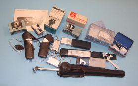 Three Minox 'Spy' cameras, with assorted accessories