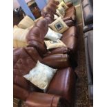 A tan brown leather three piece suite