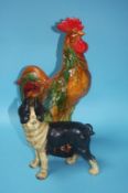 Cast model of a dog and a large pottery cockerel