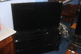 A Panasonic 42 " TV and stand (with remote in office), Sold as seen, spares or repairs.