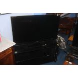 A Panasonic 42 " TV and stand (with remote in office), Sold as seen, spares or repairs.