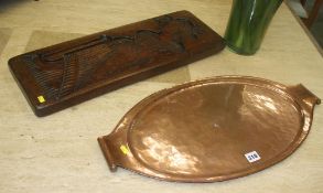 A copper tray and a carved wooden mould