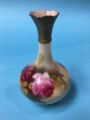 A Royal Worcester vase, decorated with roses, green mark, number G702