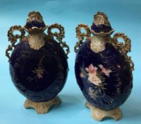 A large pair of Austrian vases, on a blue ground, decorated with flowers