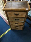 A bamboo narrow chest of five drawers