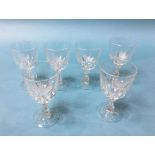 A set of six wine glasses, each etched with a bird