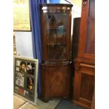 A reproduction corner cabinet