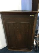 A 19th century oak hanging corner cabinet