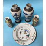 A small pair of Chinese Canton enamel vases, 15cm high, a Chinese plate and a pair of Chinese blue