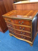 A yew wood serpentine chest of drawers