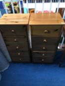 A pair of pine narrow chest of drawers