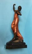 A cold cast painted bronze of a Lady holding a bunch of roses, on a stepped base, 54cm high