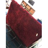 Two red wool rugs