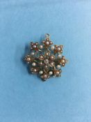 A '15ct' brooch mounted with central diamond and seed pearls, 5g, 28mm