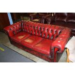 A Chesterfield oxblood three seater settee