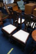 A set of four mahogany claw and ball dining chairs