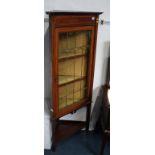 An Edwardian mahogany corner cabinet