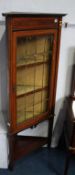 An Edwardian mahogany corner cabinet