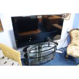 A 55" LG TV and oval stand