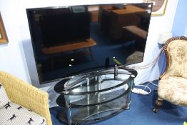 A 55" LG TV and oval stand