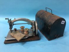 A miniature Ideal sewing machine and cover