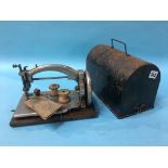 A miniature Ideal sewing machine and cover