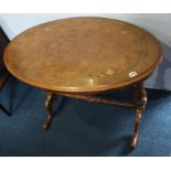 A Victorian walnut oval centre table with quarter top