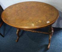 A Victorian walnut oval centre table with quarter top