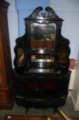 A Victorian ebonised and mirror backed side cabinet