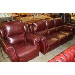 A burgundy leather three seater settee and a recliner