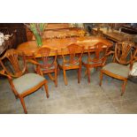 A Charles Barr yew wood extending dining table and eight chairs