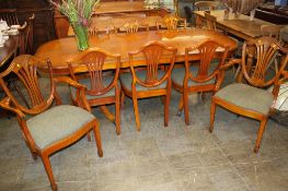 A Charles Barr yew wood extending dining table and eight chairs