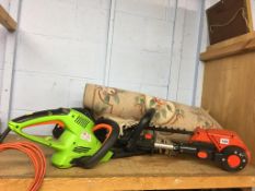 Two hedge trimmers and a rug