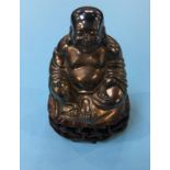 Gilt metal Buddha, on carved hardwood stand